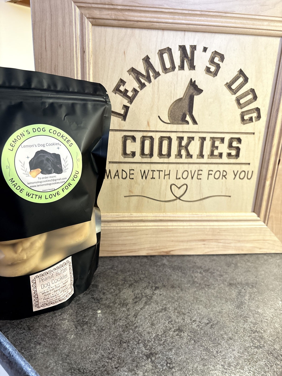 The Beg-Al 12-Pack in its black bag beside the engraved Lemon's Dog Cookies sign