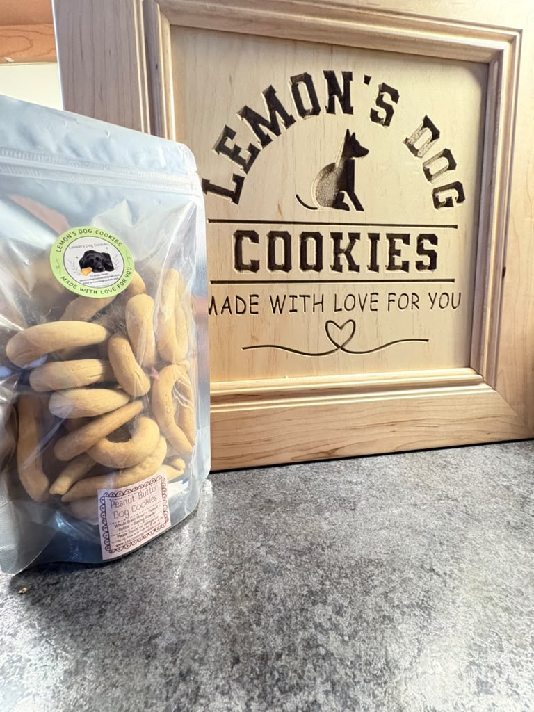 The Mini Beg-Al 16-Pack silver bag, angled view with the Lemon's Dog Cookies sign